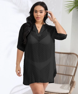 Close-up of semi-transparent black polka dot mesh texture and V-neckline detail