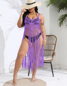 Detailed close-up of purple crochet beach cover-up with hollow knit and fringe hem details