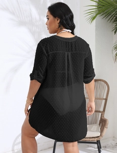 Macro detail of black Swiss dot chiffon beach cover-up showing side slit and fabric texture