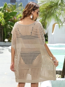 Detail view of the apricot crochet knit pattern and hollow design on a beach cover-up dress