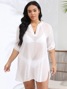 Detailed view of white swiss dot chiffon fabric and V-neckline on semi-sheer beach cover-up
