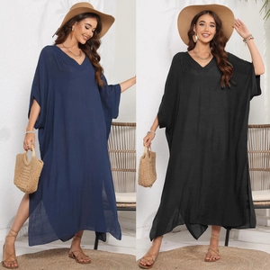 Detail showing loose V-neck kaftan dress with side slits and breathable beach fabric