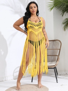 Vibrant yellow crochet beach cover-up with tassel hem for summer resort wear