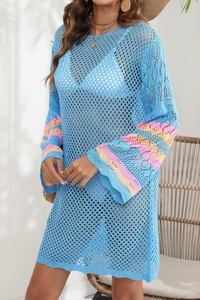 Detail of blue crochet beach cover-up with colorful striped knit bell sleeves
