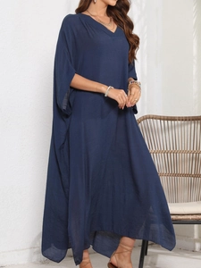 Detail of loose dark navy V-neck kaftan dress featuring batwing sleeves and light fabric