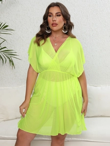 Detail of neon green mesh beach cover-up with V-neckline and elastic waist for women