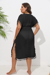 Detailed back view of a black beach cover-up featuring fringe trim and high side slits