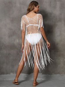 Rear view of white crochet beach cover-up dress with long tassel fringe detail