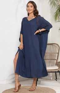 Detail of navy blue V-neck maxi beach dress with side slits and bohemian style flowy fabric