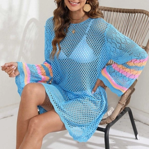 Detail of blue crochet beach cover-up featuring colorful striped flare sleeves and hollow mesh