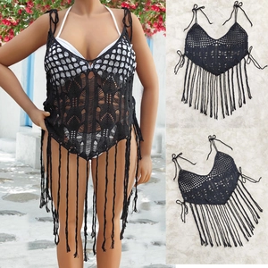 Detail showing black crochet mesh fabric with geometric patterns and long tassel fringe trim