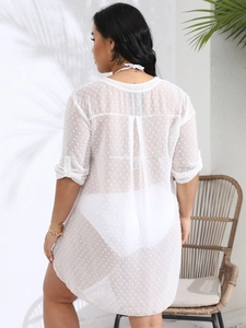 Detail of white Swiss dot beach cover-up showing semi-transparent fabric and back pleat