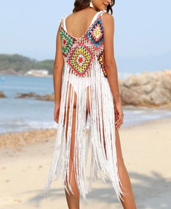 Detail of crochet beach cover-up with long white fringe and colorful geometric patchwork