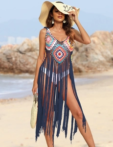 Close-up of bohemian crochet beach cover-up with long tassels and geometric patchwork