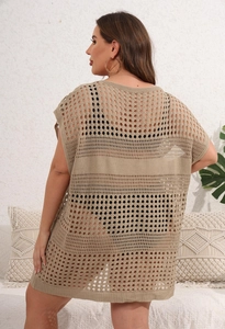 Close-up of hollow knit beach cover-up showing openwork crochet texture and sand color finish