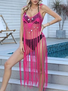 Detailed view of hot pink crochet beach dress with sequins and long fringe tassels