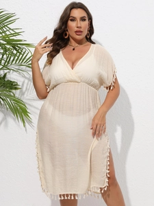 Detail of bohemian plus size beach dress featuring deep V-neck and fringe trim detail