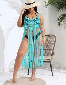 Detailed macro shot of bright turquoise crochet cover-up with intricate fringe tassels
