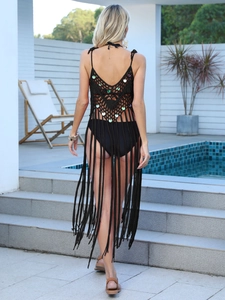 Detail of crochet beach cover-up featuring iridescent sequins and long tassels on the back