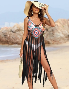 Detail of bohemian crochet beach cover-up featuring colorful patchwork and long black fringe