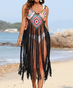 Detail of colorful crochet geometric patterns and long black fringes on beach cover-up