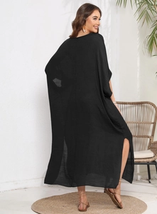 Detail of black long cover-up dress featuring side high slits and lightweight fabric