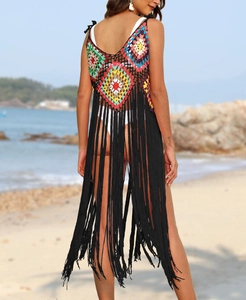 Close-up of handmade crochet beach cover-up with rainbow squares and long black tassels