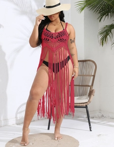 Detail of red crochet beach cover-up featuring geometric hollow patterns and long tassels