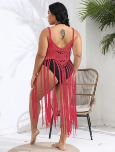 Macro detail of red crochet back pattern with long fringe tassels on beach cover-up dress