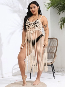 Detail of plus size crochet beach cover up with elegant tassel fringe and boho knit pattern