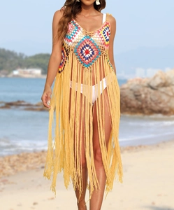 Detail of colorful bohemian crochet patterns and long tassels on a beach cover-up dress