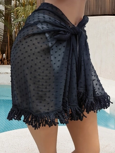 Detail of black Swiss dot mesh beach sarong featuring fringe hem and tie-up wrap waist