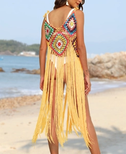 Detail of bohemian handmade crochet beach cover-up with multi-color knit and long yellow fringe