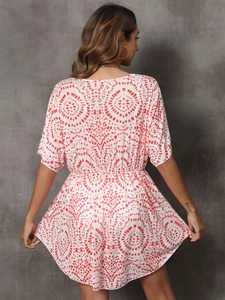 Detail of red geometric mandala print on lightweight white chiffon beach cover-up dress