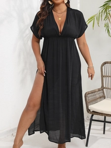 Detail of elegant black deep V-neck maxi dress with high slit for summer beach wear