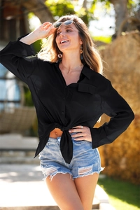 Detail of black long sleeve button-up beach cover up shirt with front pocket and tie knot hem
