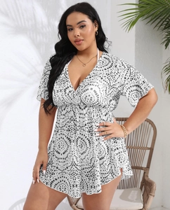 Detail of plus size V-neck dress featuring black and white geometric print and ruffle sleeves