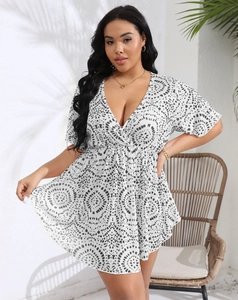 Detail of plus size summer dress with deep V-neck and black geometric circle print