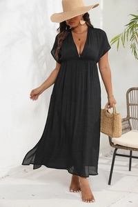 Detail of high waist pleated maxi dress featuring deep V-neck and elegant side slit