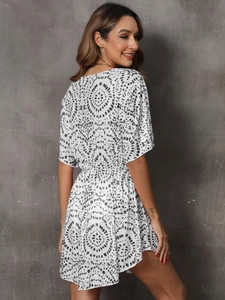 White boho summer dress with black mandala dot print and an elegant cinched waistline