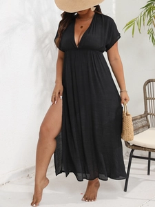 Detail of high waist slit and deep V-neck on a black maxi beach cover-up dress
