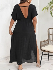 Detail of a black backless maxi dress featuring a deep V-neck and lightweight fabric texture