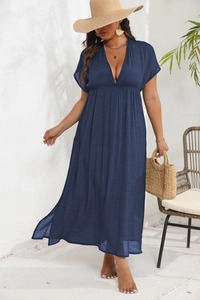 Detail of deep V-neck and pleated high waist on a dark blue maxi dress for women