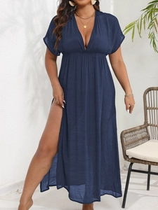 Detail shot of navy blue deep V-neck dress featuring high side slit and elastic waist design