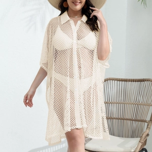 Detail of cream hollow mesh beach cover-up featuring knit texture and buttoned lapel collar