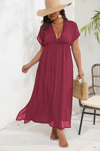Detail view of deep V-neck and high waist pleated design on this wine red maxi dress