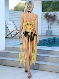 Macro detail of yellow crochet knit beach cover-up with sequins and long fringe