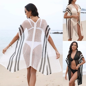 Detailed knit texture of long beach cover-up with striped pattern and hollow crochet design