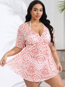 Detail of plus size beach cover-up featuring deep V-neck and red abstract circle print
