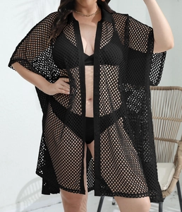 Detail view of black crochet beach cover-up with button-down design and mesh texture